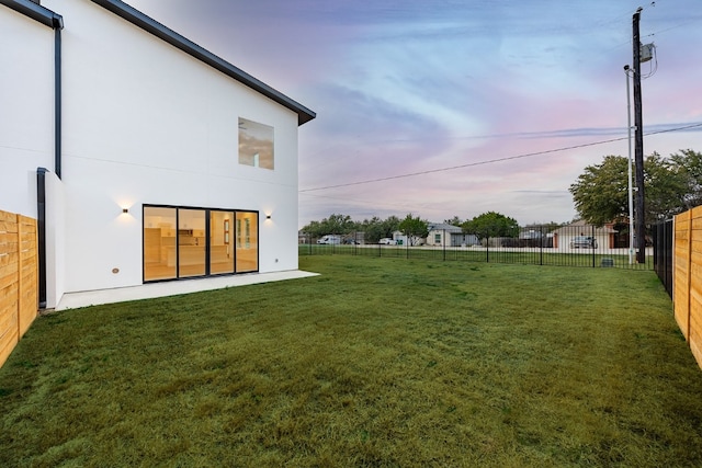 view of yard at dusk