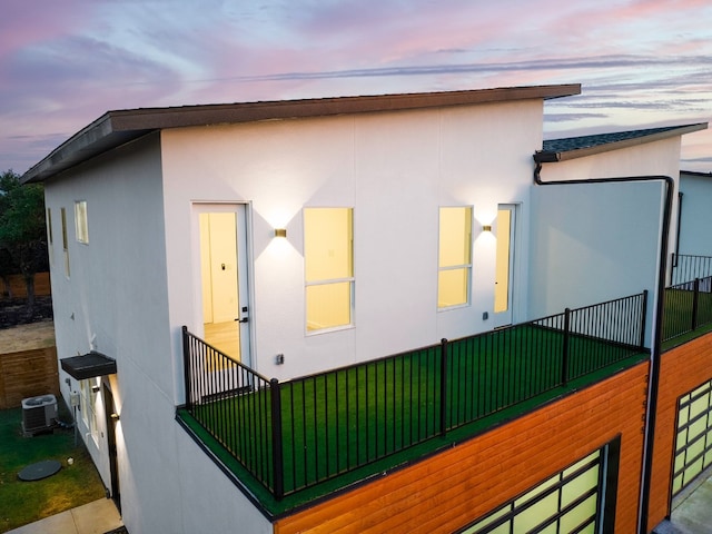 property exterior at dusk featuring central AC