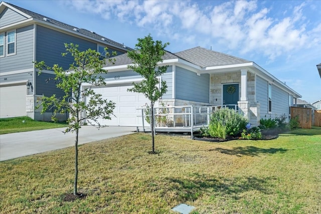 view of front of home featuring a garage and a front lawn