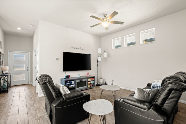 living room with hardwood / wood-style flooring and ceiling fan