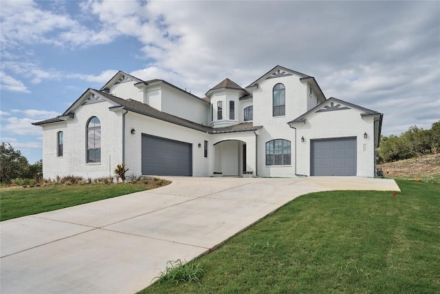 french country inspired facade featuring a front lawn and a garage