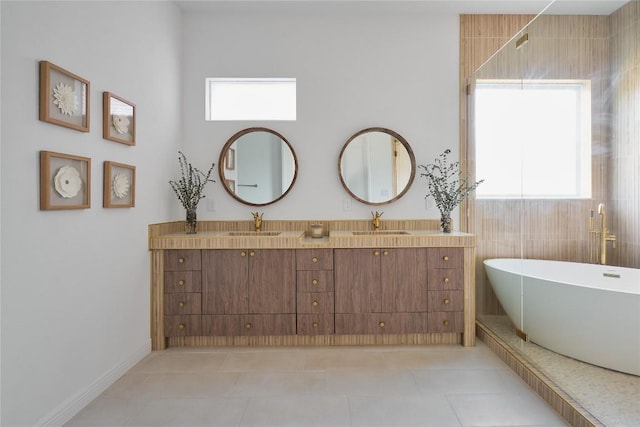 bathroom with tile patterned flooring, vanity, and a bathing tub