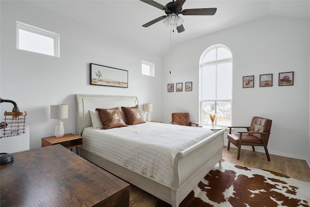 bedroom featuring ceiling fan, dark wood-type flooring, and vaulted ceiling