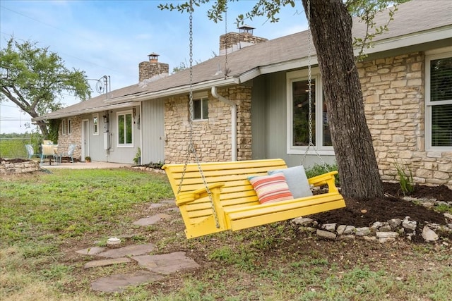 rear view of property with a lawn