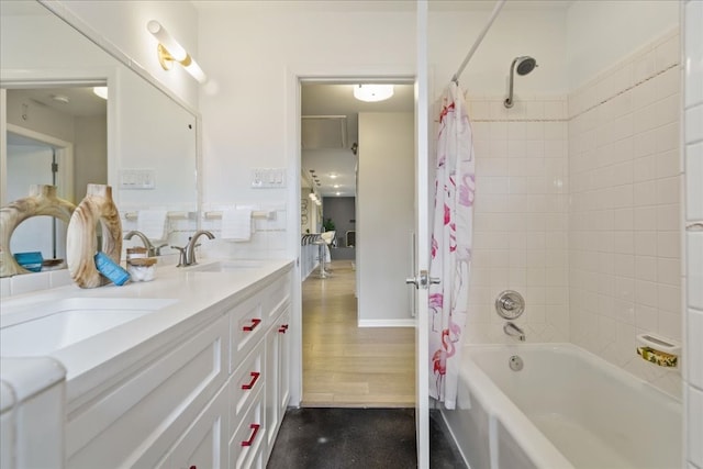 bathroom featuring vanity, shower / bathtub combination with curtain, and wood-type flooring