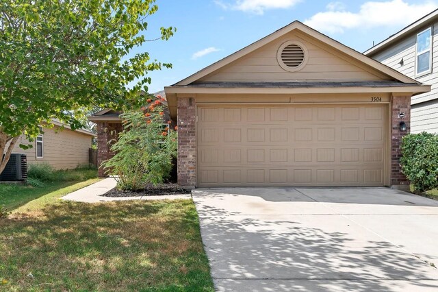 view of front of property featuring a garage, an outdoor structure, and central AC