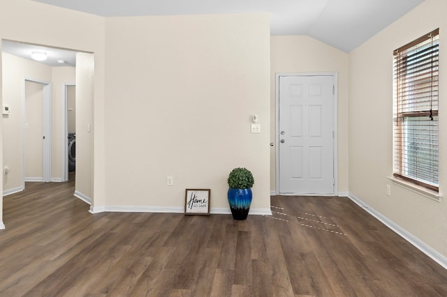 interior space featuring dark hardwood / wood-style flooring, vaulted ceiling, and a healthy amount of sunlight