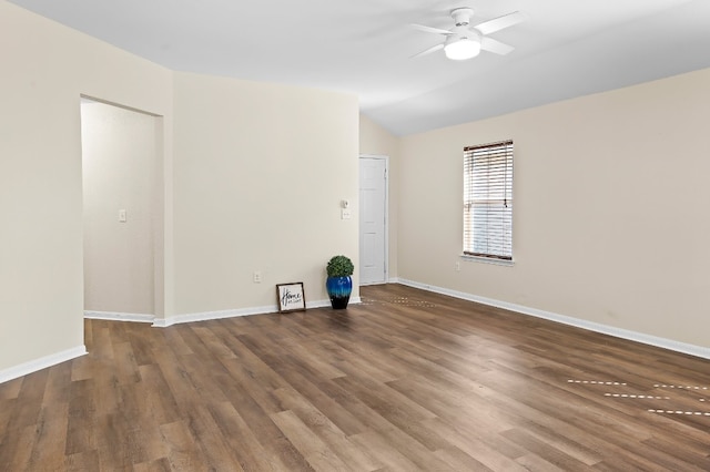 empty room with ceiling fan, dark hardwood / wood-style flooring, and vaulted ceiling