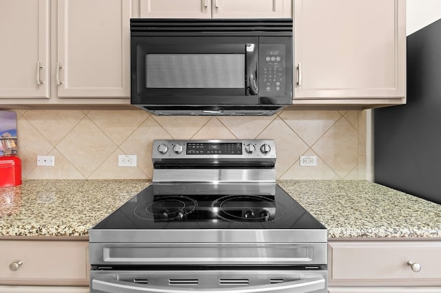 kitchen with white cabinets, stainless steel electric range, light stone countertops, and tasteful backsplash