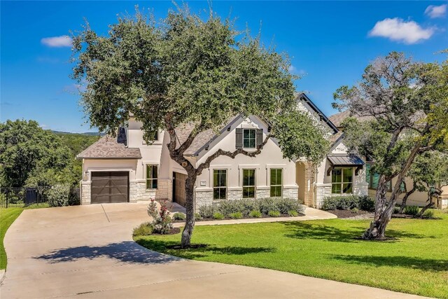 view of front of home featuring a garage and a front yard