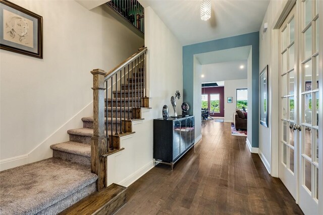 stairs featuring hardwood / wood-style flooring and french doors