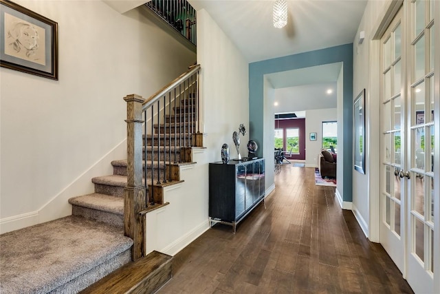 interior space featuring wood-type flooring, baseboards, and french doors