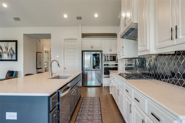 kitchen featuring stainless steel appliances, an island with sink, white cabinetry, and sink