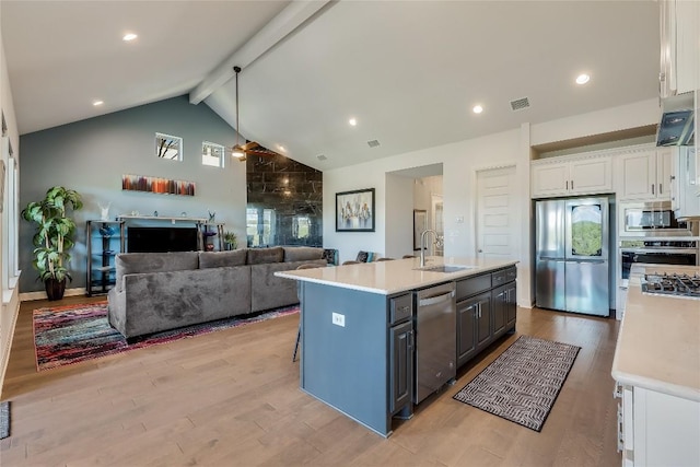 19108 Excursion Falls Way, Jonestown, TX 78645 - kitchen featuring stainless steel appliances, visible vents, beamed ceiling, light countertops, and white cabinets