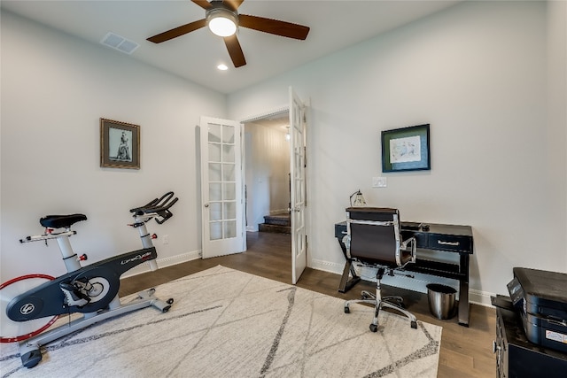 home office with ceiling fan, dark hardwood / wood-style floors, and french doors