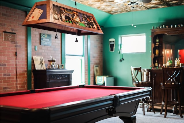 recreation room featuring brick wall, bar area, pool table, and carpet floors