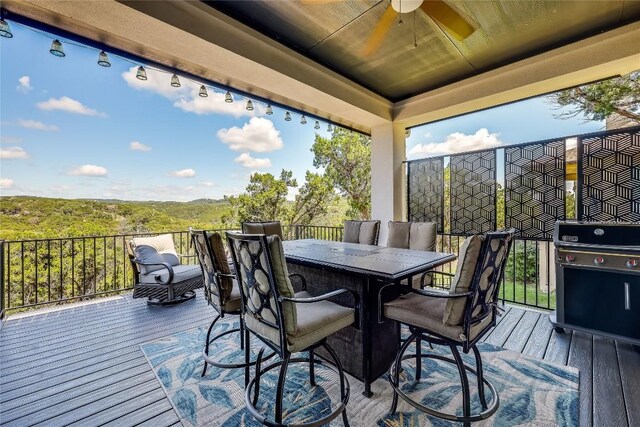 deck with area for grilling and ceiling fan