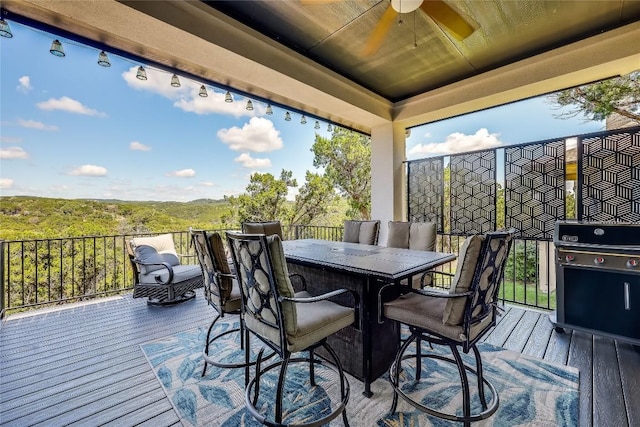 deck with a ceiling fan and a grill