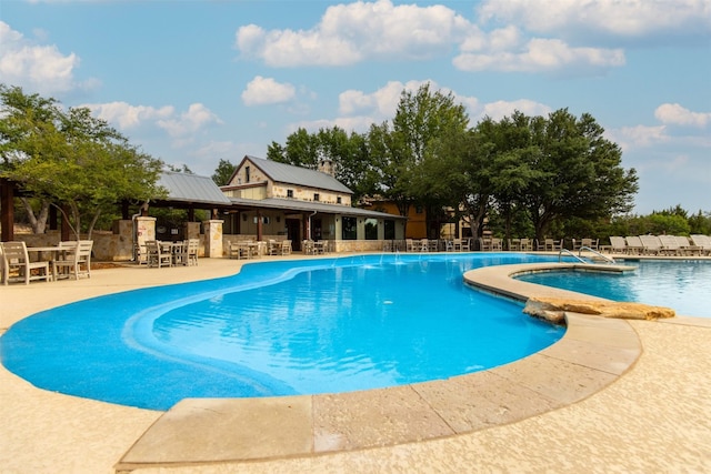 19108 Excursion Falls Way, Jonestown, TX 78645 - community pool featuring a patio, fence, and outdoor dry bar