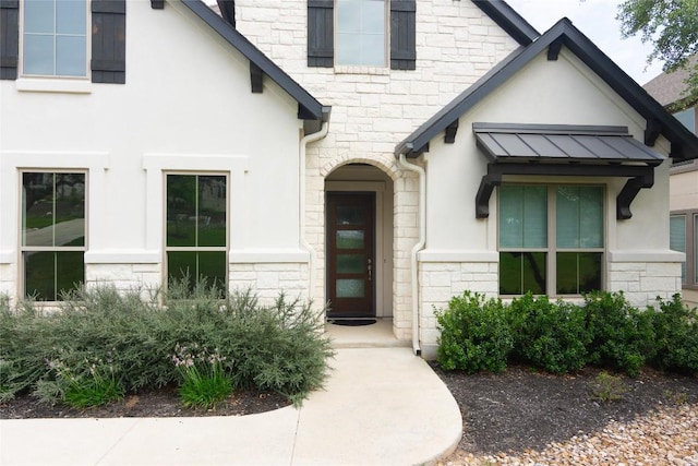 19108 Excursion Falls Way, Jonestown, TX 78645 - property entrance featuring stone siding, stucco siding, a standing seam roof, and metal roof