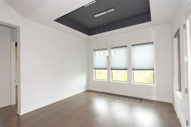 19108 Excursion Falls Way, Jonestown, TX 78645 - spare room with a tray ceiling, baseboards, and dark wood finished floors