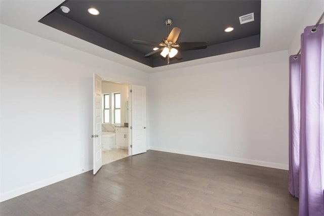 19108 Excursion Falls Way, Jonestown, TX 78645 - unfurnished room featuring wood finished floors, visible vents, ceiling fan, a raised ceiling, and baseboards