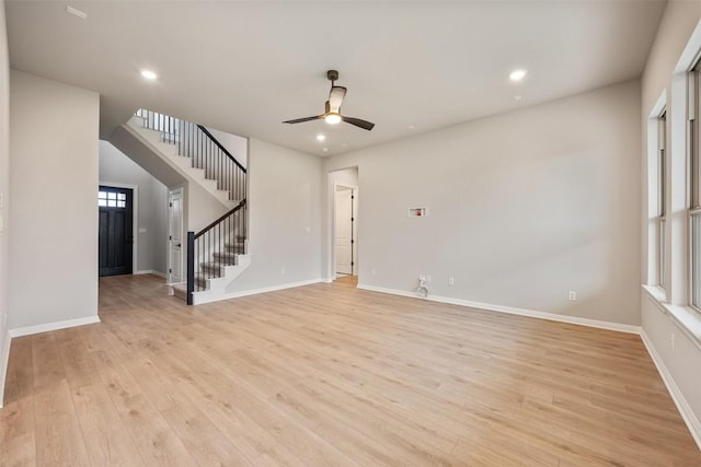 unfurnished living room featuring ceiling fan and light hardwood / wood-style floors