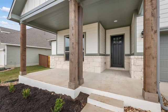 view of exterior entry featuring covered porch