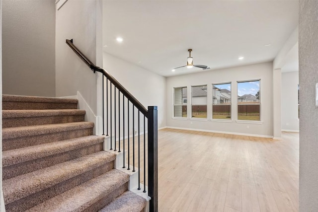 stairway with hardwood / wood-style floors