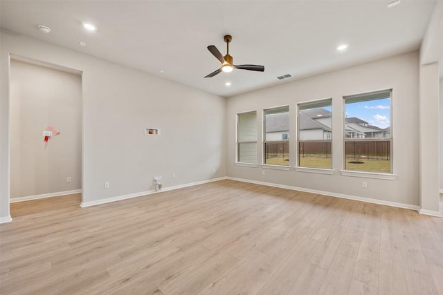 empty room featuring ceiling fan and light wood-type flooring