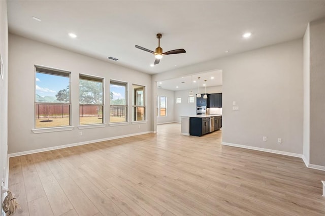 unfurnished living room with light hardwood / wood-style floors and ceiling fan