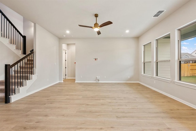 unfurnished living room with light wood-type flooring and ceiling fan