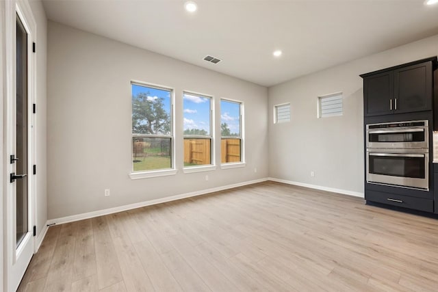 interior space with light wood-type flooring and double oven