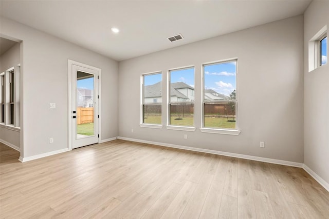 unfurnished room with light hardwood / wood-style floors