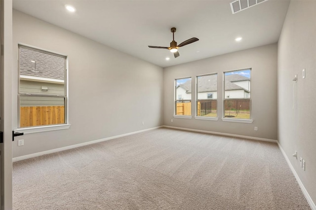 empty room featuring light colored carpet and ceiling fan