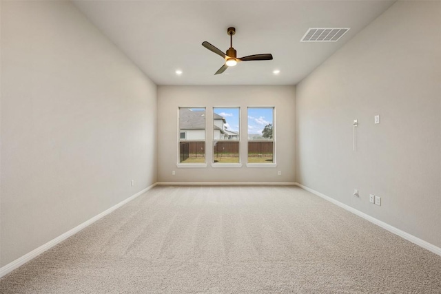 unfurnished room featuring ceiling fan and light carpet