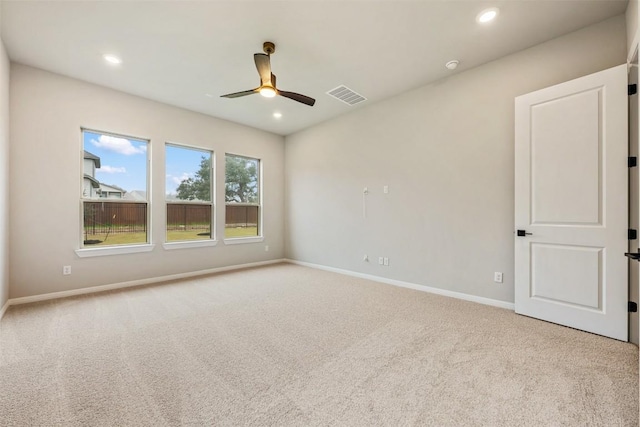 empty room with ceiling fan and light colored carpet