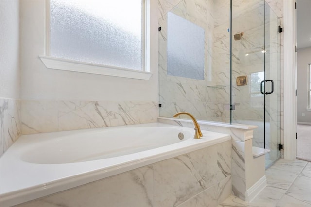 bathroom featuring separate shower and tub