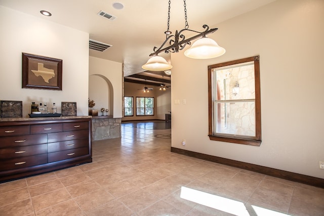 interior space featuring bar, light tile patterned floors, and ceiling fan