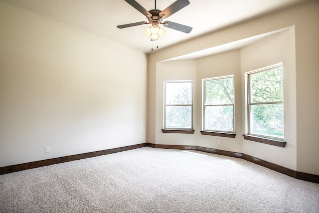 spare room with carpet and ceiling fan