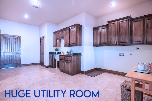 kitchen with dark stone counters and light tile patterned flooring