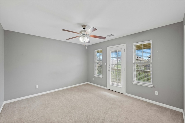 empty room with ceiling fan and light colored carpet