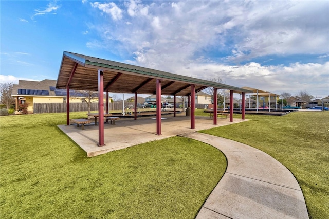 view of community featuring a lawn and a patio