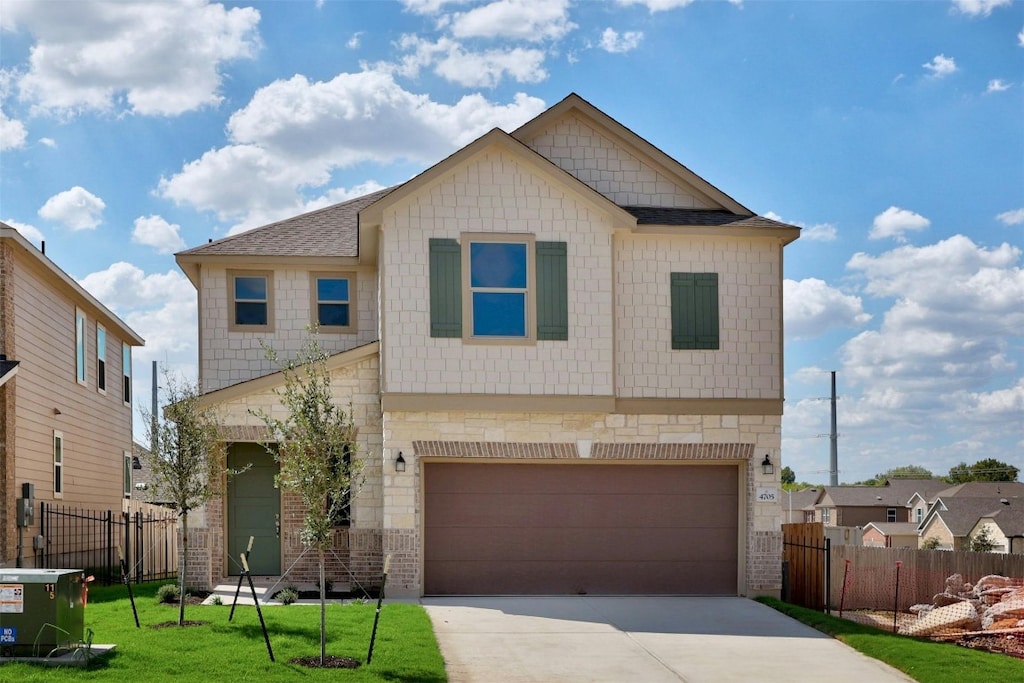 view of front facade with a garage and a front yard