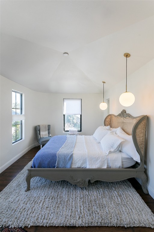 bedroom with dark hardwood / wood-style floors