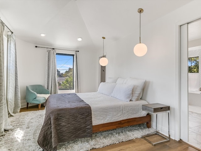 bedroom featuring vaulted ceiling and hardwood / wood-style floors