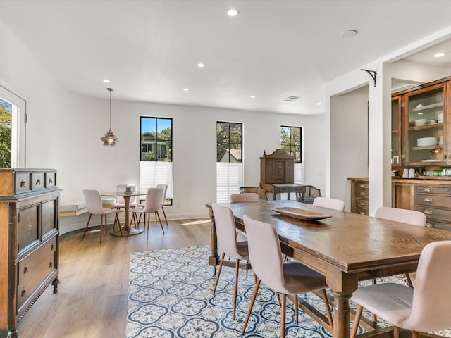 dining room featuring a wealth of natural light and light hardwood / wood-style floors