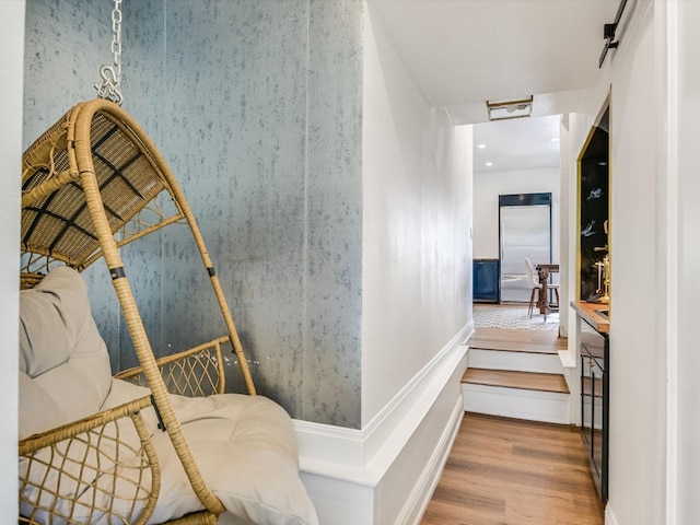 hallway with hardwood / wood-style flooring