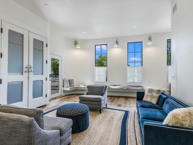 living room with wood-type flooring and french doors