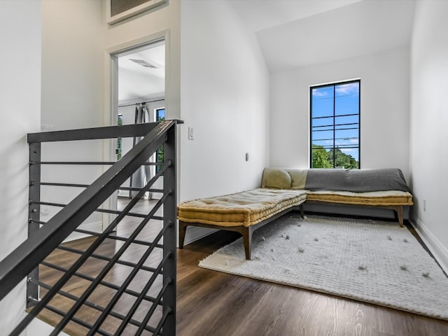 sitting room with lofted ceiling and dark wood-type flooring